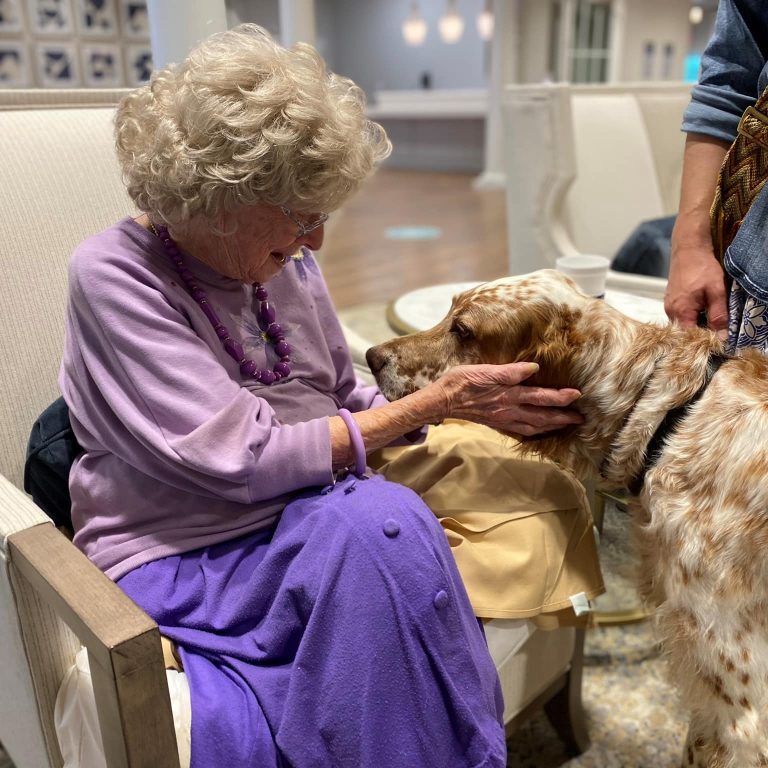 Resident visiting with a therapy dog